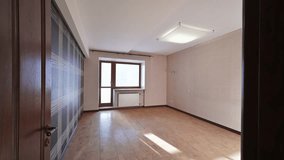 Spacious, empty room with light wood flooring, patterned wallpaper, and a large window. Perfect for renovation or new design - Powered by Shutterstock - Get 15% off with code: PIKWIZARD15