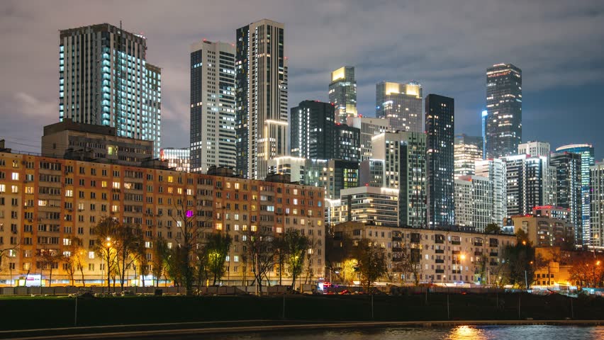 Night view of Moscow, embankment near the Beregovoy residential complex, time-lapse of clouds in the night sky