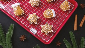 Christmas gingerbread cookies decorated with white icing on a red tray with cinnamon sticks - Powered by Shutterstock - Get 15% off with code: PIKWIZARD15