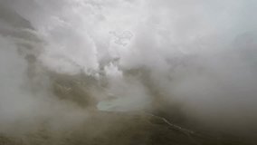 Aerial panoramic view of a lake surrounded by mountains and drifting fog at Furka Pass, Switzerland. Moody weather and misty clouds covering the alpine valley in the Swiss Alps - Powered by Shutterstock - Get 15% off with code: PIKWIZARD15