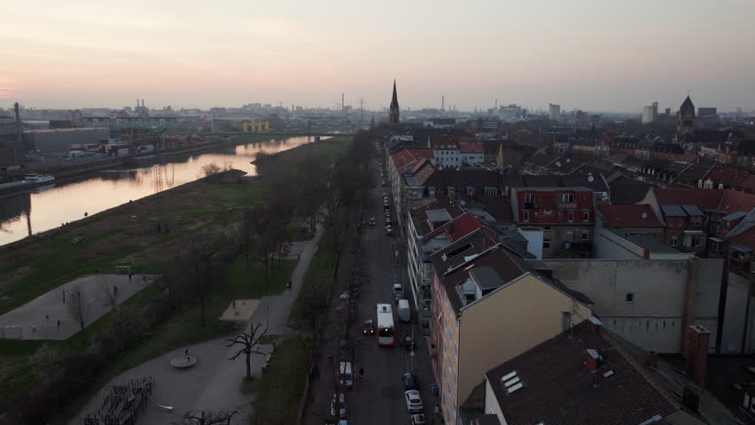Aerial perspective of Mannheim, Germany, showing urban traffic along Neckar river with industrial port background