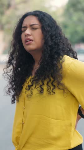Vertical Video of Indian Girl with Curly Hair Having Back Pain