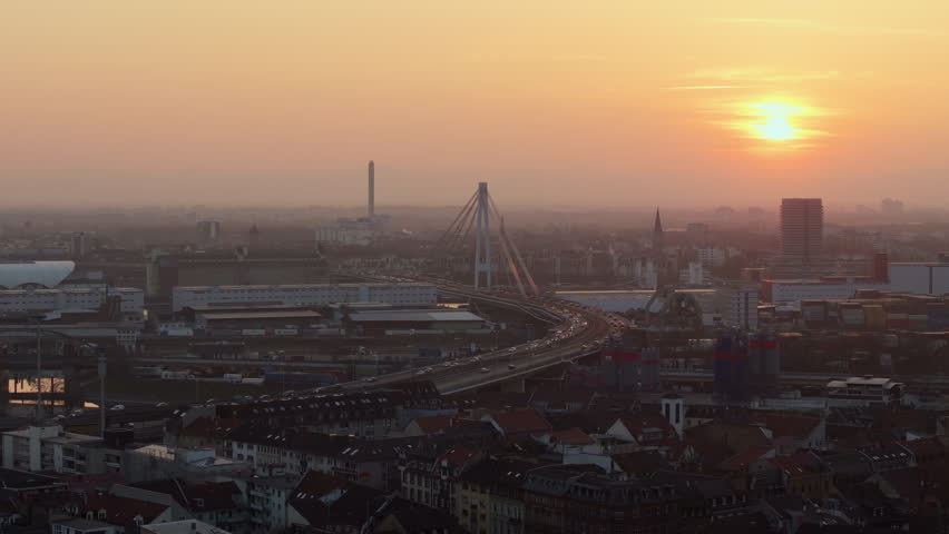 Aerial panorama of Mannheim, Germany, during a vibrant sunset with traffic over Kurt Schumacher Brucke bridge bridge