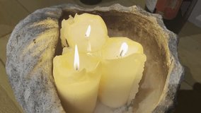 A shot of three pillar candles burning together inside a giant lantern. - Powered by Shutterstock - Get 15% off with code: PIKWIZARD15