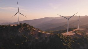 Wind turbines spaced across hilly ridges in sunrise haze, aerial view. Net-zero supported by renewable wind resources - Powered by Shutterstock - Get 15% off with code: PIKWIZARD15