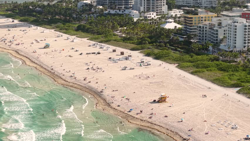 Aerial View of South Beach Miami, Florida USA, People on Sandy Shore, Ocean Waves and Beachfront Condominium Towers