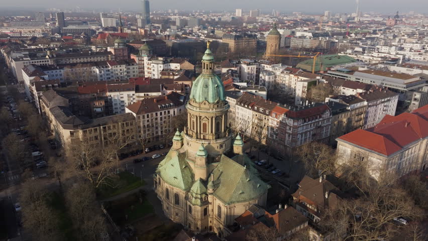 Aerial orbit around Baroque Christuskirche, iconic evangelical church in Mannheim, Germany, revealing surrounding cityscape