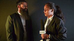 Lady Reporter Interviews Bearded Executive on Mic, Businessman shares views during live reportage, Both wear formal in discussion, Female TV Anchor question to Male Entrepreneur, Man Answers Press - Powered by Shutterstock - Get 15% off with code: PIKWIZARD15