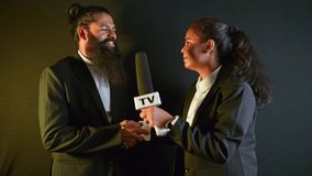 Businessman shares views during live reportage, Lady Reporter Interviews Bearded Executive on Mic, Both wear formal in discussion, Female TV Anchor question to Male Entrepreneur, Man Answers Press - Powered by Shutterstock - Get 15% off with code: PIKWIZARD15