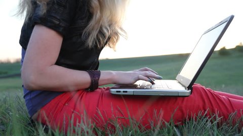 Blonde use laptop, sunset