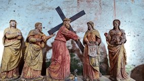 Antique wooden statues depicting Jesus Christ carrying the cross, meeting Saint Veronica, Stations of Cross scene for religious or historical content. Close-up - Powered by Shutterstock - Get 15% off with code: PIKWIZARD15