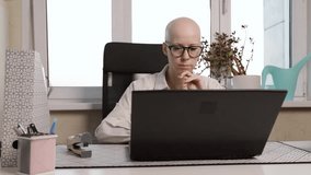 Woman in striped shirt and eyeglasses working on computer at home, digital nomad lifestyle, professional online career, self-employed freelancer - Powered by Shutterstock - Get 15% off with code: PIKWIZARD15