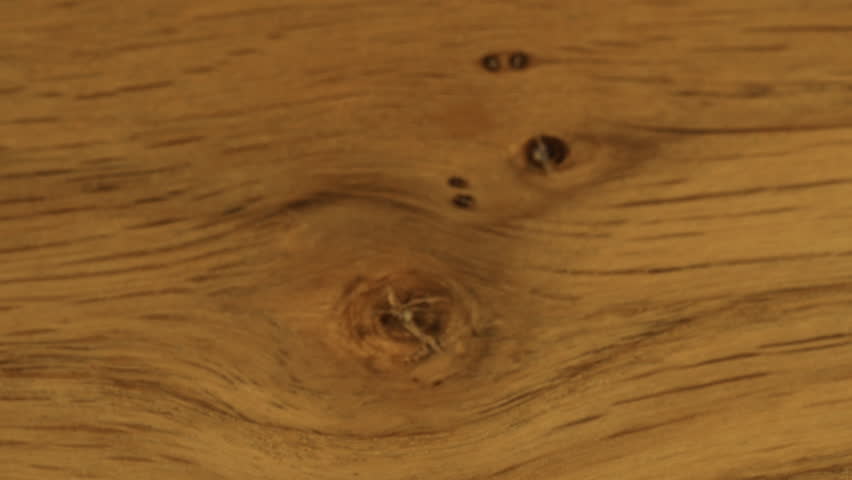 White sugar crystals are sprinkled onto wooden surface. A big pile of sugar, a lot of sugar.