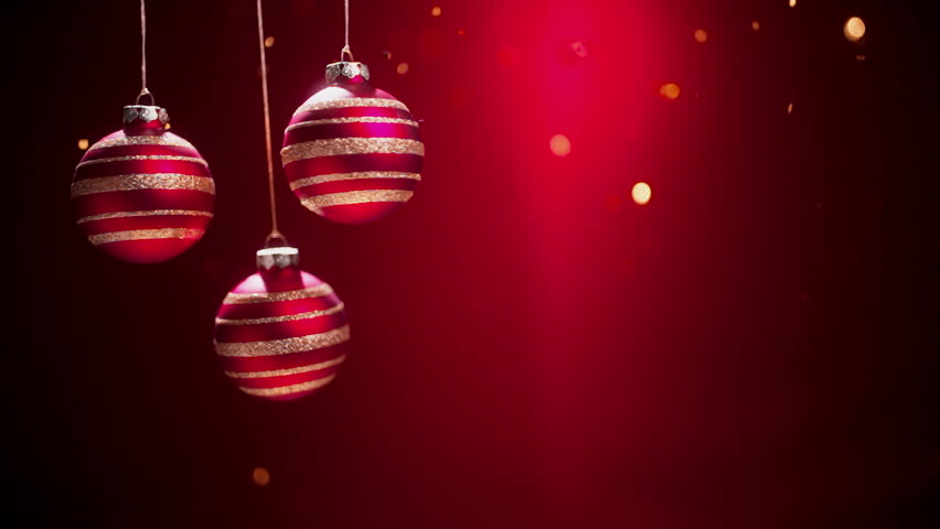 Red Christmas balls with ribbon and bow on festive background.