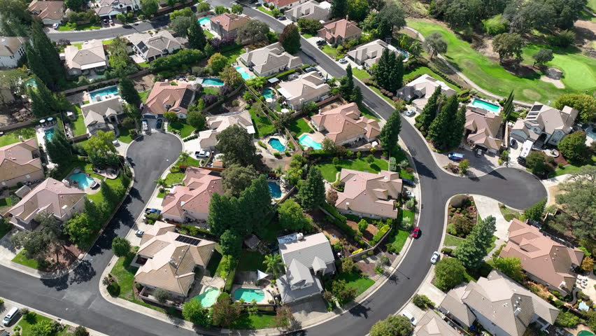Aerial view rotating over neighborhood homes in sunny Roseville, Northern California