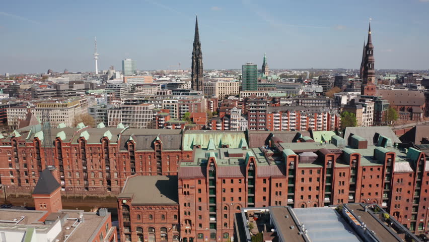 A panoramic city view from HafenCity towards Hamburg’s Old Town, with red-brick warehouses, historic church spires, and modern towers symbolizing the blend of heritage and progress in Europe.