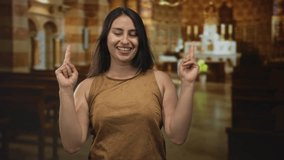 Woman praying with clasped hands in church building, smiling and looking upward; devotion faith hope. - Powered by Shutterstock - Get 15% off with code: PIKWIZARD15