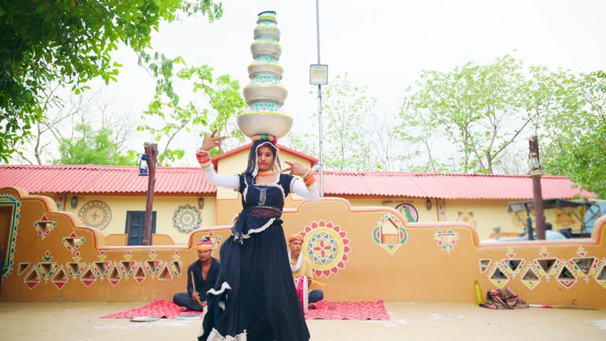 Traditional woman with veil perform swirl near rural house, Lady dance in folk style balances pot gracefully at fest, Turban musician play heritage music amid fair, Vibrant Group Act of Tribal artist