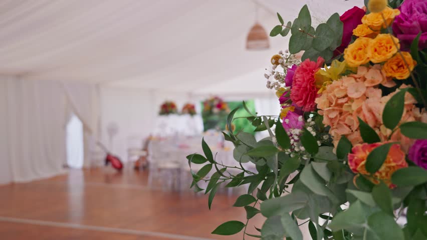 Vibrant wedding reception table setup in Dolce Vita style, colorful decorations, joyful atmosphere, elegant floral arrangements, and festive dining experience.