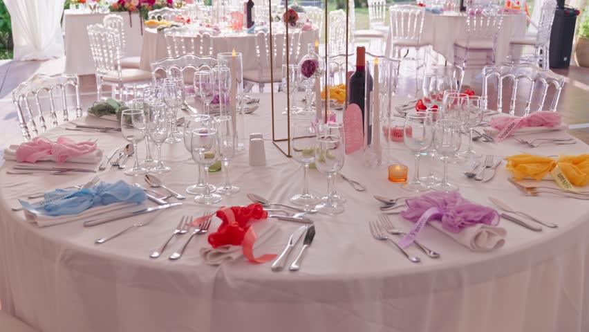 Vibrant wedding reception table setup in Dolce Vita style, colorful decorations, joyful atmosphere, elegant floral arrangements, and festive dining experience.