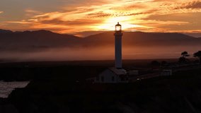 Aerial view of the Pigeon Point Lighthouse piercing through the thick fog as the sun rises, Pescadero, California, United States. - Powered by Shutterstock - Get 15% off with code: PIKWIZARD15