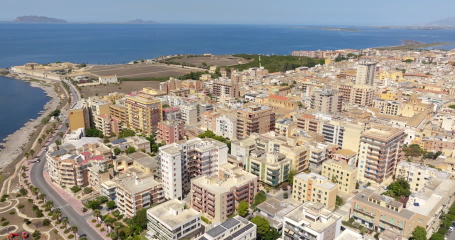 Aerial view of houses and buildings in the historic center of Marsala, in the province of Trapani, Sicily, Italy. In the background, on the horizon, there are the islands of Mozia and Isola Grande.