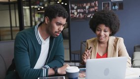 Coworkers watching laptop seeing social media icons rising and cheering marketing win. Collaboration, achievement, celebration, enthusiasm, modernoffice, teamwork, digitalmedia - Powered by Shutterstock - Get 15% off with code: PIKWIZARD15