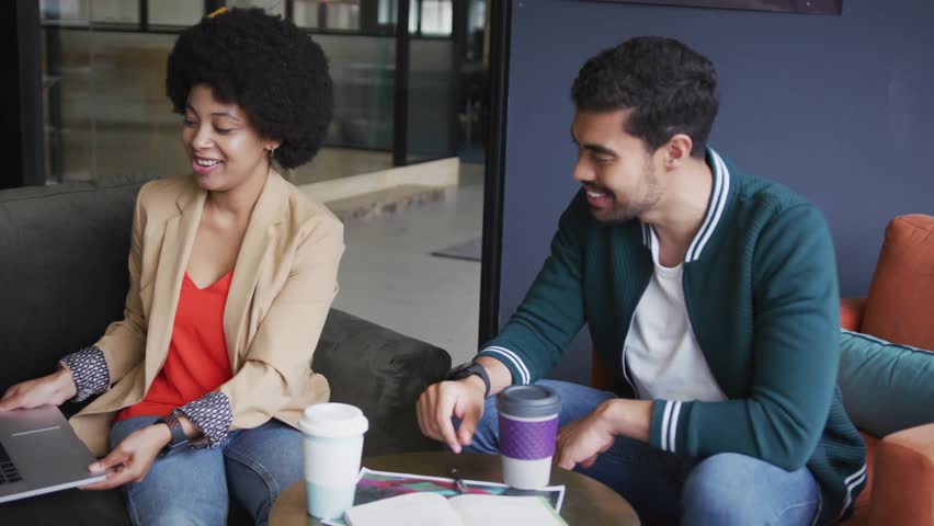 Colleagues clicking trackpad, tilting laptop, watching floating numbers guiding business analysis. Collaboration, teamwork, data visualization, modern office, professional, innovation, digital - Powered by Shutterstock - Get 15% off with code: PIKWIZARD15
