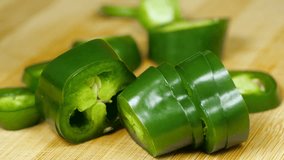 Chef Hand Chopping Green Jalapeno Pepper with Sharp Knife onto Cutting Board into Pile of Slices in Fast Motion - Powered by Shutterstock - Get 15% off with code: PIKWIZARD15