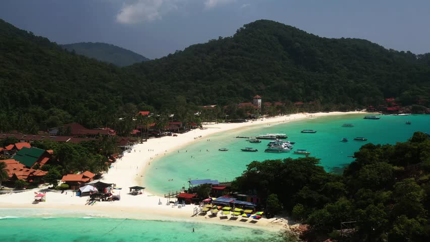 Aerial view of Long Beach with clear turquoise waters and tourists on Redang Island. Malaysia