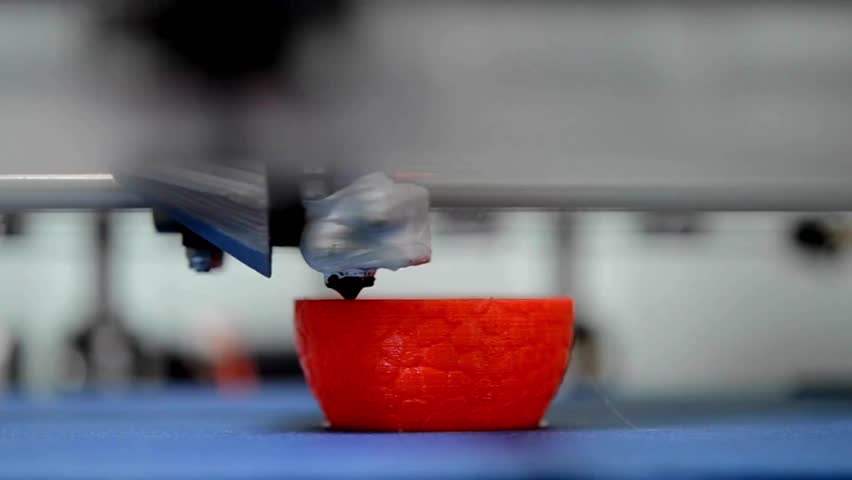 A modern 3D printer is printing a metal turbine. 3d printer printing a black object, Three dimensional 3d printer working at printing lab. science
