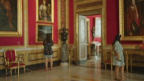 Blurred museum interior with soft bokeh, gilded frames, red walls and polished marble floor background; background backplate copyspace. - Powered by Shutterstock - Get 15% off with code: PIKWIZARD15