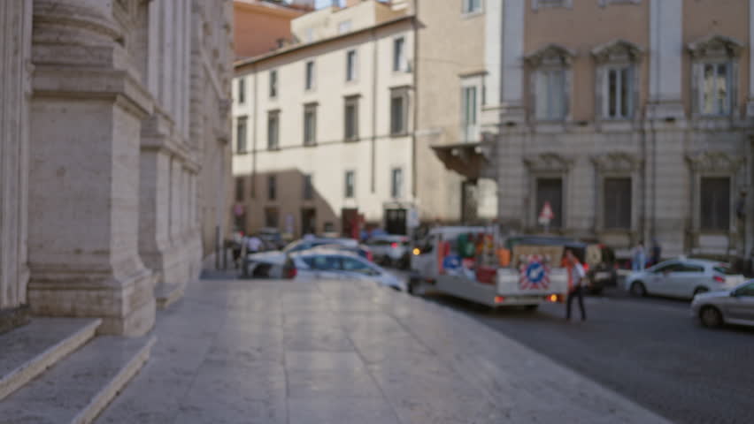 Blurred street scene in rome with shallow bokeh and softly defocused stone steps and pavement; background backplate copyspace template calm.