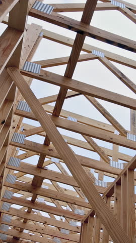 Wooden framing in progress under works day in new housing development beam framework