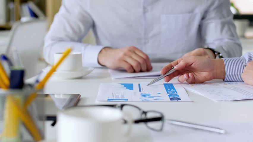 Leader team finance presentation in meeting, documents or charts on table in office. Marketing, data and analytics of female ceo boss