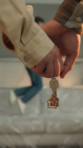 African American couple hands holding key from apartment happy son kid boy jumping on couch enjoying new home family custody unknown parents with child in own house moving day relocation real estate