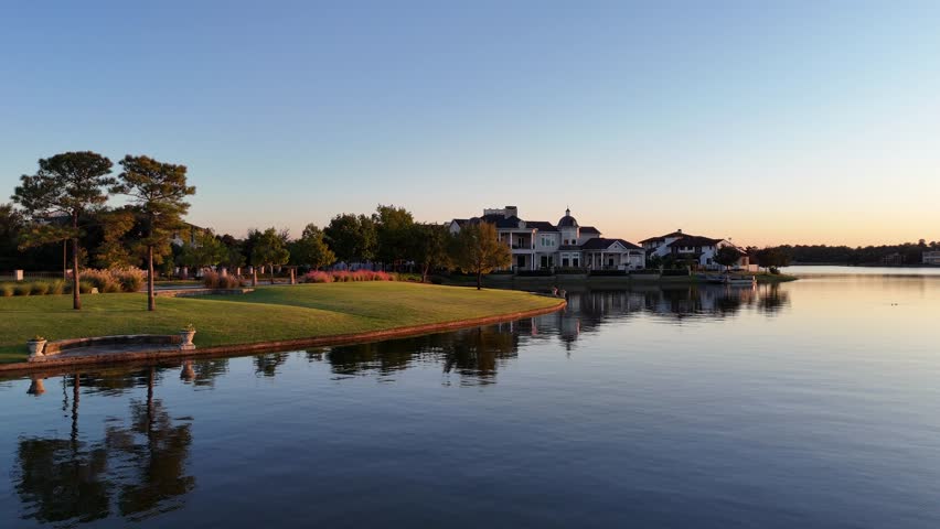 Aerial view of luxurious Woodlands houses neighborhood by the lake in Houston, Texas, USA at sunset time