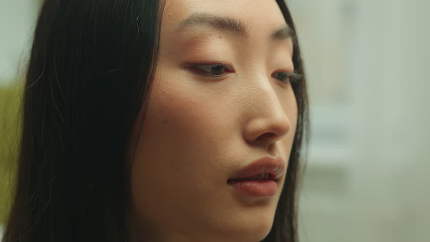 Closeup portrait calm Asian woman sniffing flower smell aroma plant holding white chrysanthemum Chinese Korean Japanese ethnic female beautiful lady enjoying organic spring perfume sensual fragrance