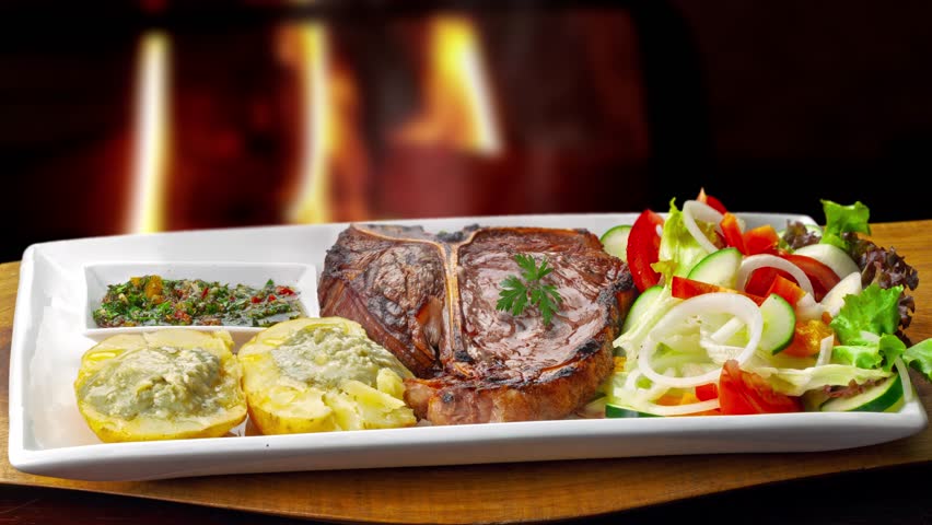  t bone steak with potatoes and salad