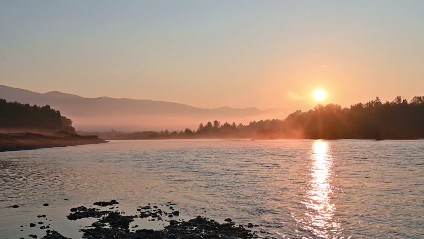 Magnificent landscape of the morning sun rising over the river
