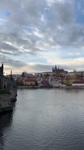 A view across the Vltava river on Prague Castle with St. Vitus Cathedral rising above Lesser town (Mala Strana) at cloudy day. Prague, Czech Republic  