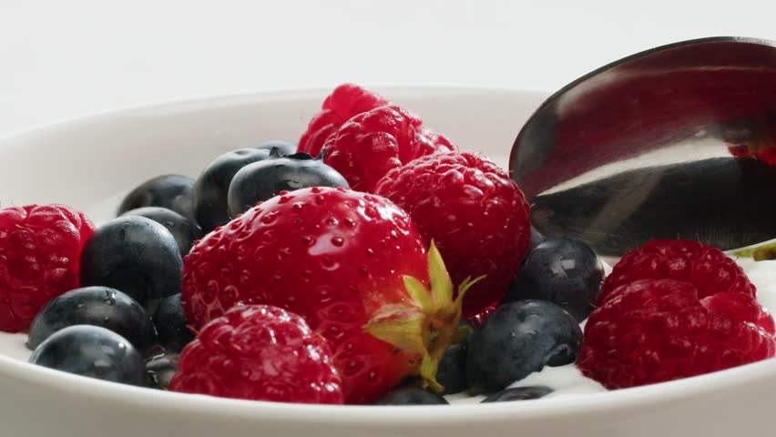 Enjoy a Delicious Yogurt with Fresh, Colorful Berries for a Healthy and Tasty Snack Option