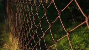 Rusty metal mesh fence illuminated by sunset light. - Powered by Shutterstock - Get 15% off with code: PIKWIZARD15