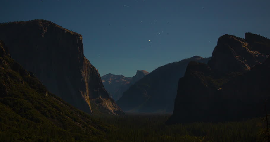 A stunning night timelapse of star trails above Tunnel View in Yosemite National Park, California. Long-exposure stars move gracefully over the iconic valley and granite peaks.