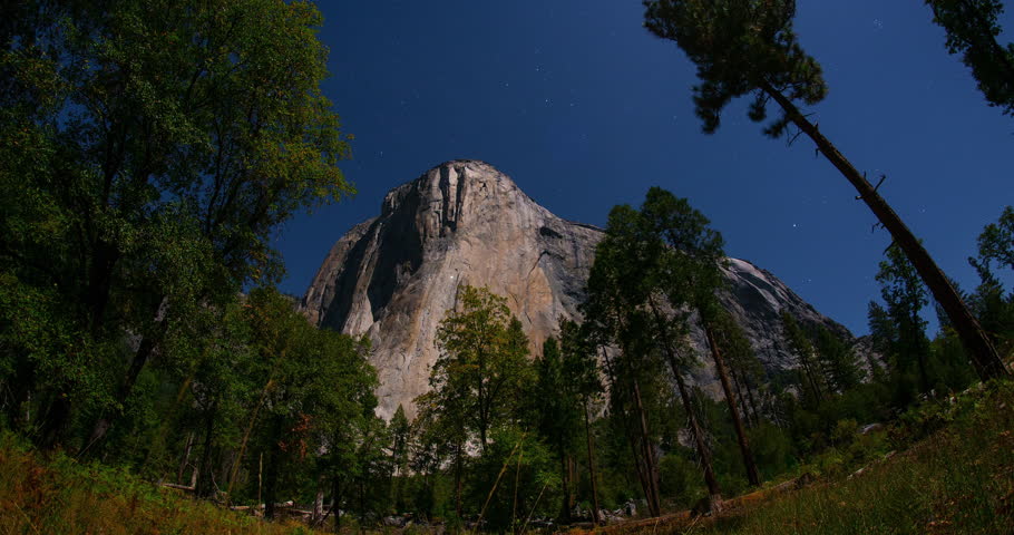 Dazzling star trails spiral around El Capitan under a bright moonlit sky in Yosemite National Park, California. Long-exposure timelapse capturing nature’s motion over iconic granite cliffs.