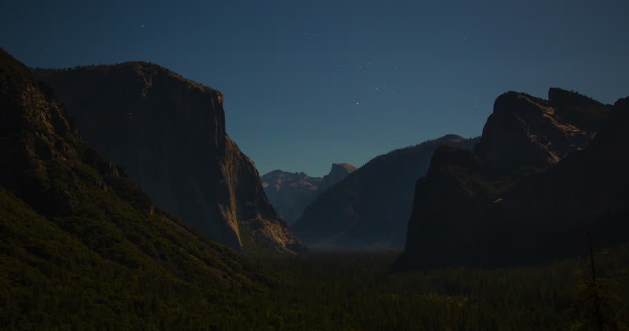 A stunning night timelapse of star trails above Tunnel View in Yosemite National Park, California. Long-exposure stars move gracefully over the iconic valley and granite peaks.