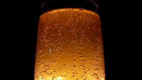 Sparkling amber beverage in a clear glass on black background refreshing summer drink closeup - Powered by Shutterstock - Get 15% off with code: PIKWIZARD15