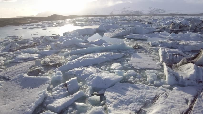 Aerial view of Jokulsarlon glacier lagoon with iceberg floating and mountains on background - Beautiful drone view of Vatnajokull area, nature and travel concepts