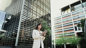 Businesswoman using digital tablet in urban setting - Powered by Shutterstock - Get 15% off with code: PIKWIZARD15