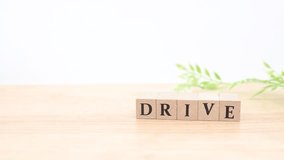 A wooden car and DRIVE letter blocks. A piece that evokes driving and car life. - Powered by Shutterstock - Get 15% off with code: PIKWIZARD15